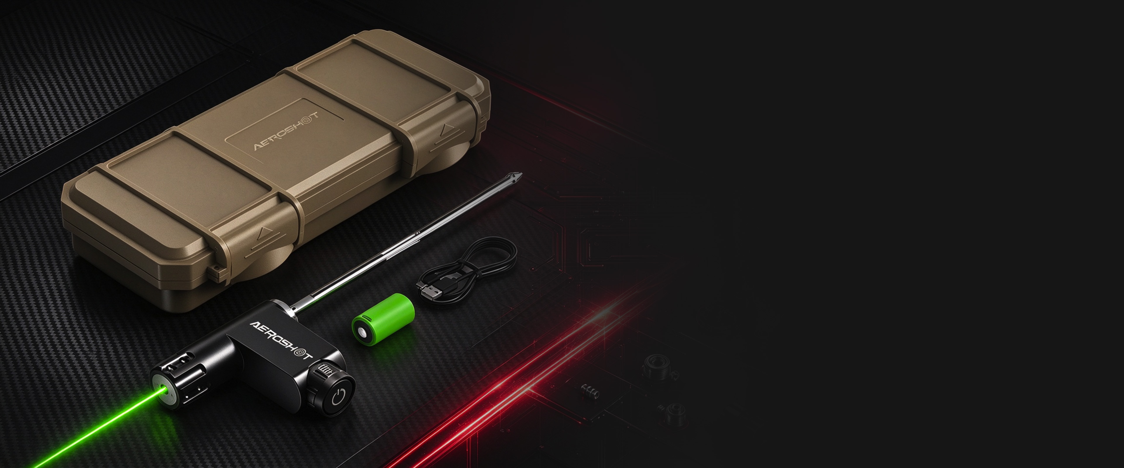 AEROSHOT green laser bore sight projecting a green beam beside its tan hard case, extension rod, battery and USB cable on carbon fibre
